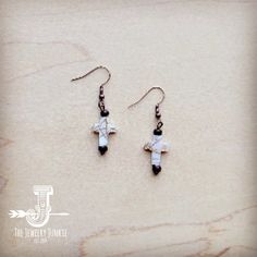 A pair of western-inspired earrings made with genuine wood and mother-of-pearl