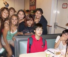 a group of people posing for a photo in a restaurant