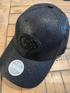 a black baseball cap with glitter on it