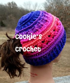 a woman wearing a crochet hat with the words cookie's crochet on it