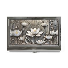 a metal box with white flowers and leaves on the front, in an art deco style