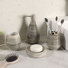 bathroom accessories including toothbrushes and soap dispenser sitting on counter top