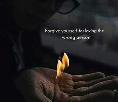 a person holding a lit candle in their hand with a quote above it that reads, forget yourself for loving the wrong person