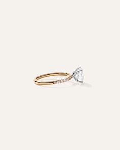 a gold ring with a white diamond in the middle