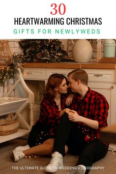 a man and woman sitting on the floor in front of a christmas tree with text overlay that reads 30 heartwarming christmas gifts for newlyweds