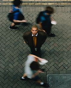 an overhead view of people walking down the street with their hands on their hipss