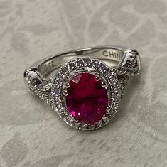 Very Lovely!! High Gallery Sterling Silver 925, 2ct Oval Cut Hot Pink/ Red CZ Solitaire with accents, Gorgeous Gallery, fancy detail! Center stone tests as a Ruby, I am sure it is Lab created.  Size- 5  Center Stone Measures : 9mm x 7mm  Weight : 5.3 grams  Stamped: 925 UD Cz  Condition : very good condition !  Thank you for Visiting! Hot Pink Engagement Ring, Luxury Silver Ruby Ring With Halo Design, Red Sterling Silver Diamond Ring With Halo Setting, Formal Pink Ruby Ring In Sterling Silver, Luxury Hallmarked Silver Ruby Ring, Red Sterling Silver Ruby Ring Hallmarked, Pink Engagement Ring, Bling Wedding, Royal Jewelry