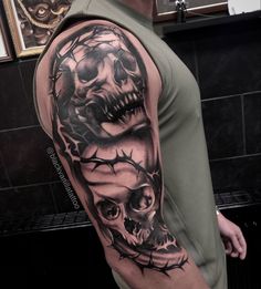 a man's arm with a skull and crown of thorns tattoo on it