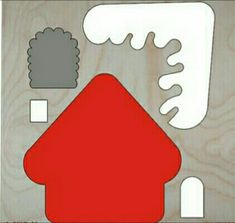 an image of a red house cut out on wood with white and gray shapes around it