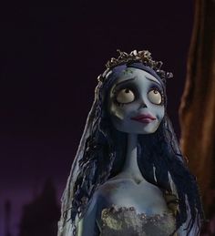 the corpse bride is dressed in white and has long black hair, wearing a tiara