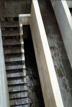 stairs going up to the top of a concrete structure with water running down them and on either side