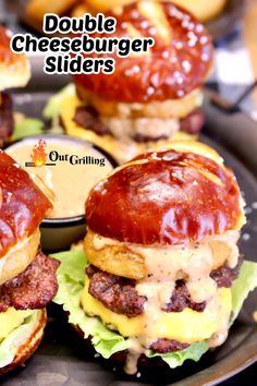 three cheeseburger sliders are sitting on a plate