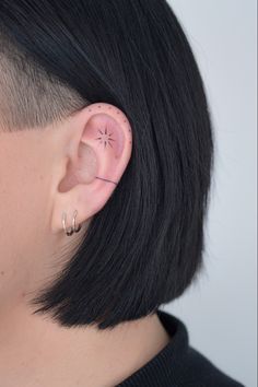 a close up of a person with ear piercings