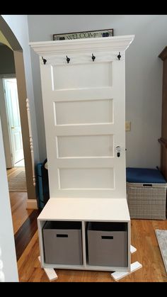 a white bookcase with two bins on the bottom and an open shelf above it