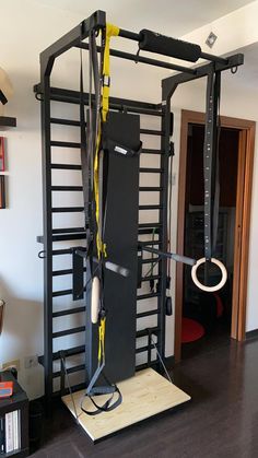 a gym equipment set up in the middle of a room with other items on it