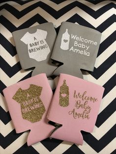 three pink and gray baby announcement coasters on a black and white chevron background