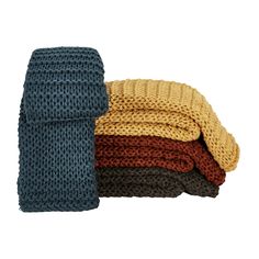 three knitted blankets stacked on top of each other