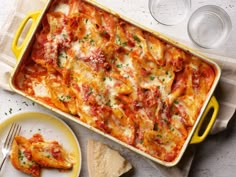 a yellow casserole dish filled with lasagna and cheese