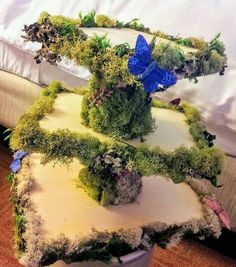 a bed with moss and blue butterflies on it