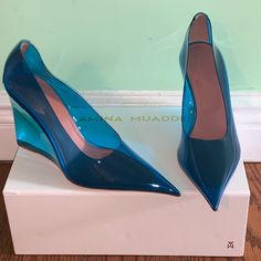 Brand New In Box Amina Muaddi Women's 'Ane' 95mm See-Through Pvc W/ Leather Trim Wedge Pumps Sizes: 9 B Us (39 Eu) Color/Details: Blue Colored Transparent Pvc 'Glass' Pumps With Leather Trim At The Heel, 3.8" Covered Wedge Heel, And Pointed Toe. Pvc Upper, Leather Lining Made In Italy! Original Retail Price: $1140 These Are A Beautiful Pair Of Shoes To Wear For A Night On The Town. Makes A Great Gift Too. Blue Patent Leather Heels With Sculpted Heel, Blue Wedge Heels For Evening, Modern Blue Pointed Toe Heels, Blue Modern Heels With Sculpted Heel, Modern Blue Heels With Reinforced Heel, Modern Blue Heels With Sculpted Heel, Modern Blue High Heels, Muaddi Shoes, Amina Muaddi Shoes