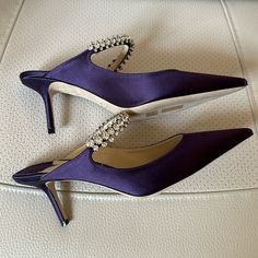 Bing Mules In Purple Satin With Crystal Details, 65 Mm Height. Worn Only A Few Times. Size 39. Purple Pointed Toe Heels For Cocktail, Purple Heels With 4-inch Almond Toe, Luxury Purple Pointed Toe Heels, Jimmy Choo Purple Heels, Purple Sandals With 4-inch Heel And Pointed Toe, Jimmy Choo Bing, Purple Satin, Jimmy Choo Shoes, Jimmy Choo