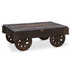 an old fashioned wooden cart with wheels on it's sides and holes in the middle