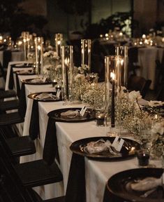 a long table is set with candles and place settings for dinner guests to enjoy the meal