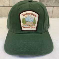 the yellowstone national park hat is green and has a patch on it