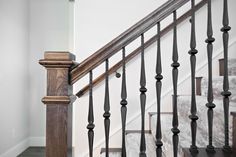 an image of a stair case in a house with wood and metal handrails