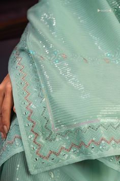 Enhance your ethnic wardrobe with this stunning sea green georgette saree adorned with exquisite sequin work, thread work, and zari work. Perfect for weddings, festivals, parties, and other special occasions, this saree is sure to make you stand out in the crowd.
The vibrant sea green color is eye-catching and flattering on all skin tones, making it a versatile and timeless addition to your collection.
The 5.50-meter saree comes with unstitched blouse material, allowing you to customize the perf Pista Green Pre-draped Saree With Mirror Work For Navratri, Festive Pista Green Pre-draped Saree With Gota Work, Pista Green Georgette Pre-draped Saree With Dupatta, Pista Green Sequined Georgette Lehenga, Festive Pista Green Anarkali Set With Sequins, Pista Green Anarkali Set With Sequins, Elegant Green Pre-draped Saree With Gota Work, Green Pre-draped Saree For Diwali Celebration, Pista Green Pre-draped Saree With Gota Work For Diwali