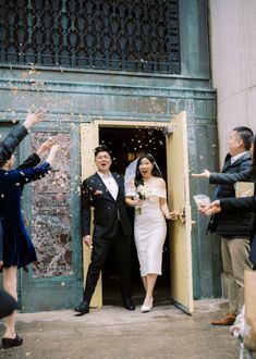 a bride and groom are leaving the church with confetti thrown in the air