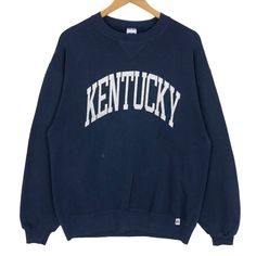 Vintage 90s University Of Kentucky Wildcats crewneck sweatshirt by Russell Athletic in navy blue colour. Pullover sweater with printed spell out logo on the front. Still in good condition EXCEPT few drops of paint stains on the front and slightly defect (tear) on the left wrist. SEE THE PICTURES FOR MORE DETAILS. CONDITION : 7/10 MEASUREMENT Pit : 22 inch Length : 28 inch Shoulder : 22 inch Arm Length : 24 inch Size On Tag : L Recommended Size : M PAYMENT We accept PayPal only. The item will be Oversized Collegiate Crew Sweater, Collegiate Crew Neck Sweatshirt For Fall, Collegiate Crew Neck Sweater With Ribbed Cuffs, Crew Neck Sweater For Campus In Winter, Winter Crew Neck Sweater For Campus, Collegiate Crew Neck Sweater With Graphic Print, Collegiate Crew Neck Sweatshirt With Ribbed Cuffs, Navy Letter Print Sweater For Winter, Navy Sweater For College In Fall