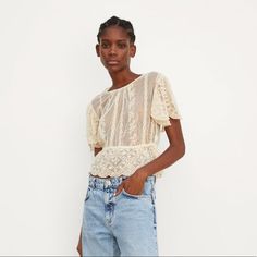 Cropped Top With A Round Neckline And Short Sleeves. Featuring Matching Embroidery, An Elasticated Waist And A Buttoned Opening At The Back- Never Worn Casual Lace Blouse With Lace Work, Beige Lace Blouse With Floral Embroidery, Summer Embroidered Lace Top With Lace Trim, Chic Lace Tops With Floral Embroidery, Chic Lace Blouse With Floral Embroidery, Beige Lace Blouse With Short Sleeves, Chic Zara Lace Top, Beige Lace Top With Short Sleeves, Embroidered Short Sleeve Lace Blouse