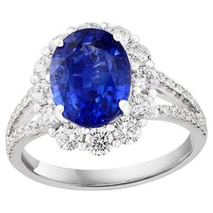 Features a beautiful 3.45-carat oval shape blue sapphire at the center. Surrounded by 12 brilliant-cut round diamonds weighing 0.98 carats in total. Diamonds are also set halfway all over the shank of the ring. The weight of the 36 accent diamonds is 0.22 carats. Made in 18k white gold. Size 6.5 US (Sizable). Style available in different price ranges. Prices are based on your selection of the 4C’s (Carat, Color, Clarity, Cut). Don't hesitate to get in touch with us for more information. Gia Certified Oval Sapphire Diamond Ring, Oval Sapphire Ring Gia Certified, Blue Oval Diamond Ring, Royal Blue Oval Gemstone Rings, Oval Gemstone Rings In Royal Blue, Blue Sapphire Ring With Brilliant Oval Cut, Royal Blue Oval Sapphire Jewelry, Oval Sapphire Jewelry In Royal Blue, Oval Blue Sapphire Ring With Diamond Accents