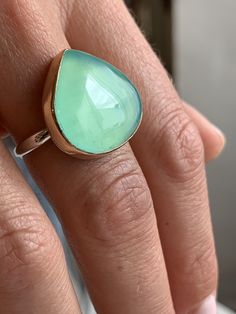 Like the depths of the most tranquil Caribbean waters this large teal Peruvian Opal is set in 14k yellow gold on our Sterling Silver Nestle band. Approximate stone size: 22mm x 20mm Approximate CT weight: 18ct Mohs hardness: 5-6.5 This mixed metal ring is lovingly handmade in our Hudson Valley studio and is one of a kind. Currently a size 8 it can be resized prior to shipping at no charge. Marquis Ring, Baguette Necklace, Hexagon Necklace, Mixed Metal Rings, Chalcedony Necklace, Snow Crystal, Bubble Necklaces, Imperial Topaz, Ruby Crystal