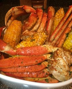 crab legs and corn on the cob in a bowl