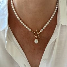 This classic white pearl necklace features a gorgeous 12x15mm smooth teardrop white freshwater pearl that drops elegantly from the gold filled toggle clasp. The necklace is made with 6mm high quality genuine AAA grade natural round freshwater pearls that have high luster and luminescence. These natural pearls have a superior polish, are perfectly calibrated, and are uniform in size.  - Not dyed, treated or color enhanced. 100% natural. - Photos taken outside in natural lighting and in a light bo Pear-shaped Pearl Drop Necklaces, Classic Pear-shaped Pearl Necklace With Charm, Classic Necklace With Teardrop Pearl Charm, Classic Teardrop Necklace With Pearl Charm, Classic Pearl Charm Toggle Necklace, Classic Toggle Necklace With Pearl Charm For Gift, Classic Pearl Drop Pear-shaped Necklace, Classic Teardrop Baroque Pearl Necklace, Classic Pear-shaped Pearl Drop Necklace