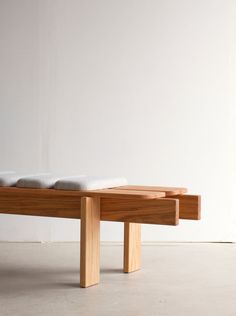 a wooden bench sitting on top of a white floor