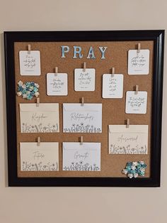 a cork board with notes pinned to it that say pray and have flowers on them