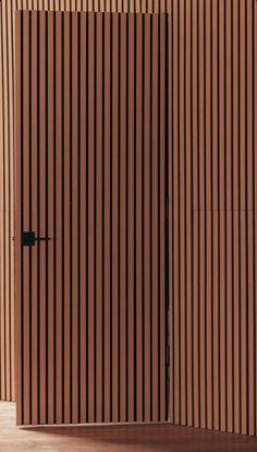 an open door on the side of a building with vertical slatted wood panels