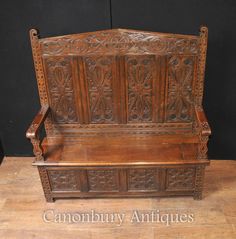 an old wooden bench sitting on top of a hard wood floor