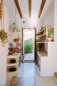 an open door leading to a kitchen with pots and pans