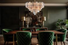 an elegant dining room with green velvet chairs