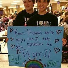 two boys holding up a sign that says, even though we're gay, i can take you straight to prom