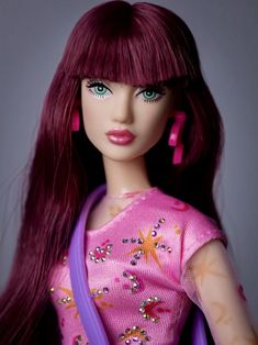 a close up of a barbie doll with long red hair and bright purple eyeshadow