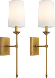 two wall lights with white shades on them