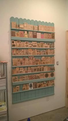 a wall mounted display with lots of stamps on it's sides in a room