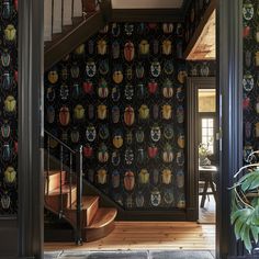 an entry way with wallpaper and stairs