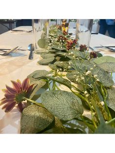 the table is set with flowers and place settings