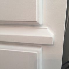 a close up view of the door handle on a white refrigerator with no frosting